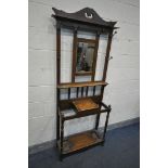 AN EDWARDIAN OAK HALL STAND, with six hooks flanking a bevelled mirror, width 76cm x depth 28cm x