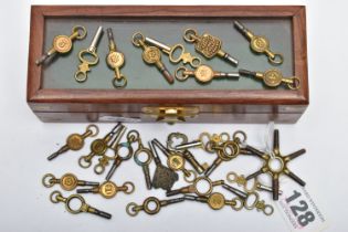 A SELECTION OF WATCH KEYS, a selection of watch keys varying sizes, encased in a small wooden box
