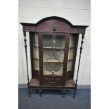 AN EARLY 20TH CENTURY MAHOGANY DISPLAY CABINET, with concave glass panels, and turned supports,