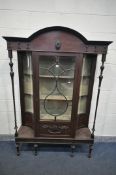 AN EARLY 20TH CENTURY MAHOGANY DISPLAY CABINET, with concave glass panels, and turned supports,