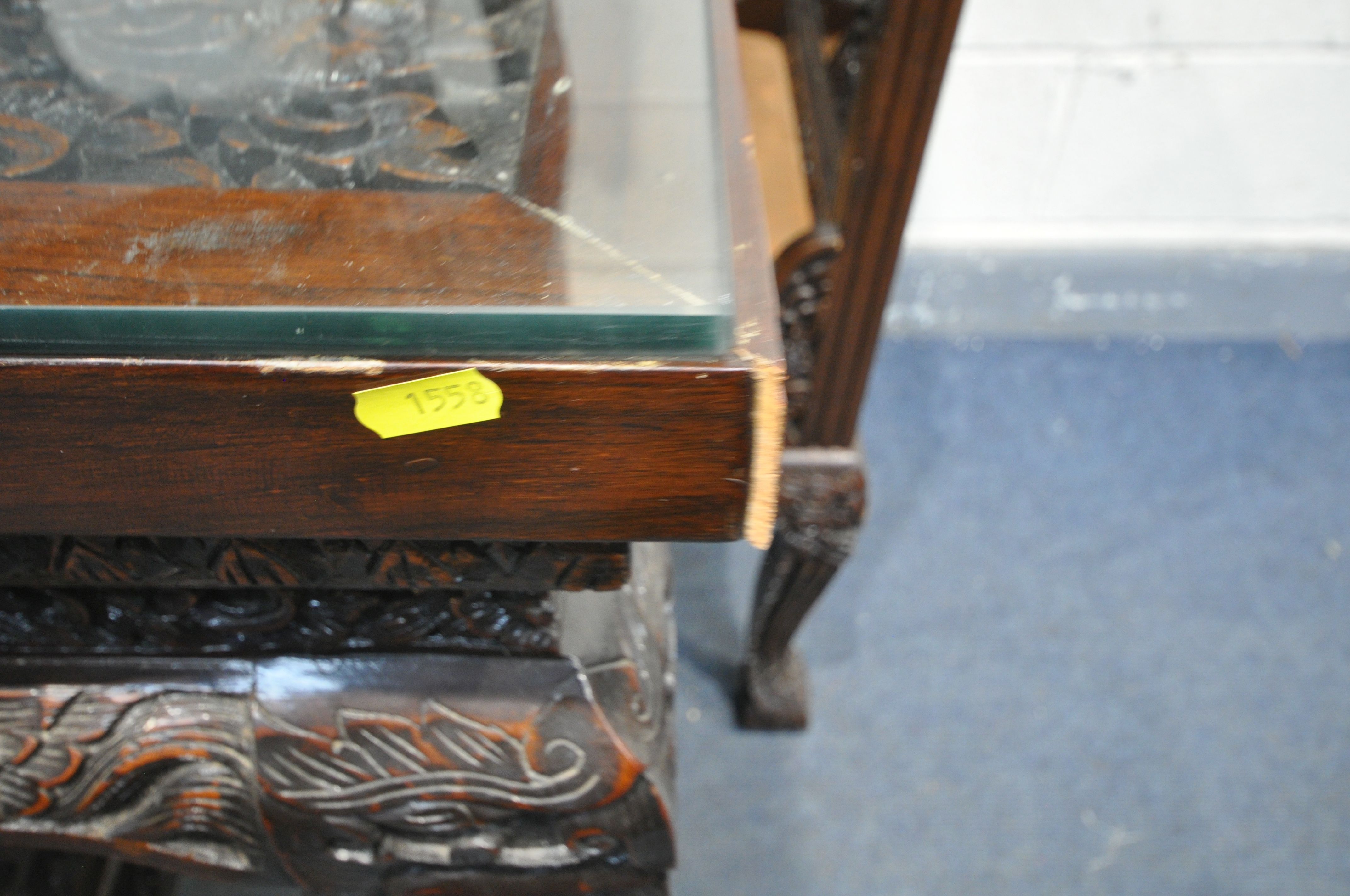 A 20TH CENTURY THAI ORIENTAL HEAVILY CARVED STAINED TEAK DINING TABLE, the recessed top with a - Image 2 of 7