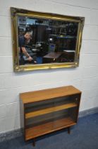 AN GILT FRAMED BEVELLED EDGE WALL MIRROR, 106cm x 75cm, an oval mahogany coffee table, and a mid-