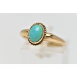 A 9CT GOLD TURQUOISE RING, designed with an oval turquoise cabochon, collet set with a fine rope