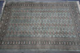 A KAYAM PAKISTAN TEAL GROUND RUG, with a multistrap border, and eighty four medallions, length 250cm