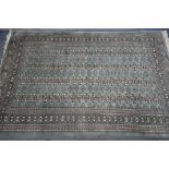 A KAYAM PAKISTAN TEAL GROUND RUG, with a multistrap border, and eighty four medallions, length 250cm