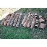 TWO TRAYS CONTAINING A QUANTITY OF TERRACOTTA PLANT POTS (condition:-mostly in poor condition, as