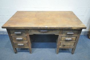 A 1940'S OAK DESK, with six assorted drawers, with later fitted Bakelite handles, width 143cm x