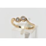 A 9CT YELLOW GOLD DIAMOND TWO STONE CROSSOVER RING, set with two round brilliant cut diamonds,