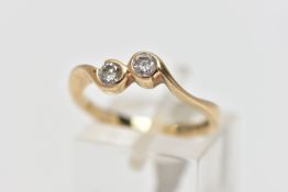 A 9CT YELLOW GOLD DIAMOND TWO STONE CROSSOVER RING, set with two round brilliant cut diamonds,