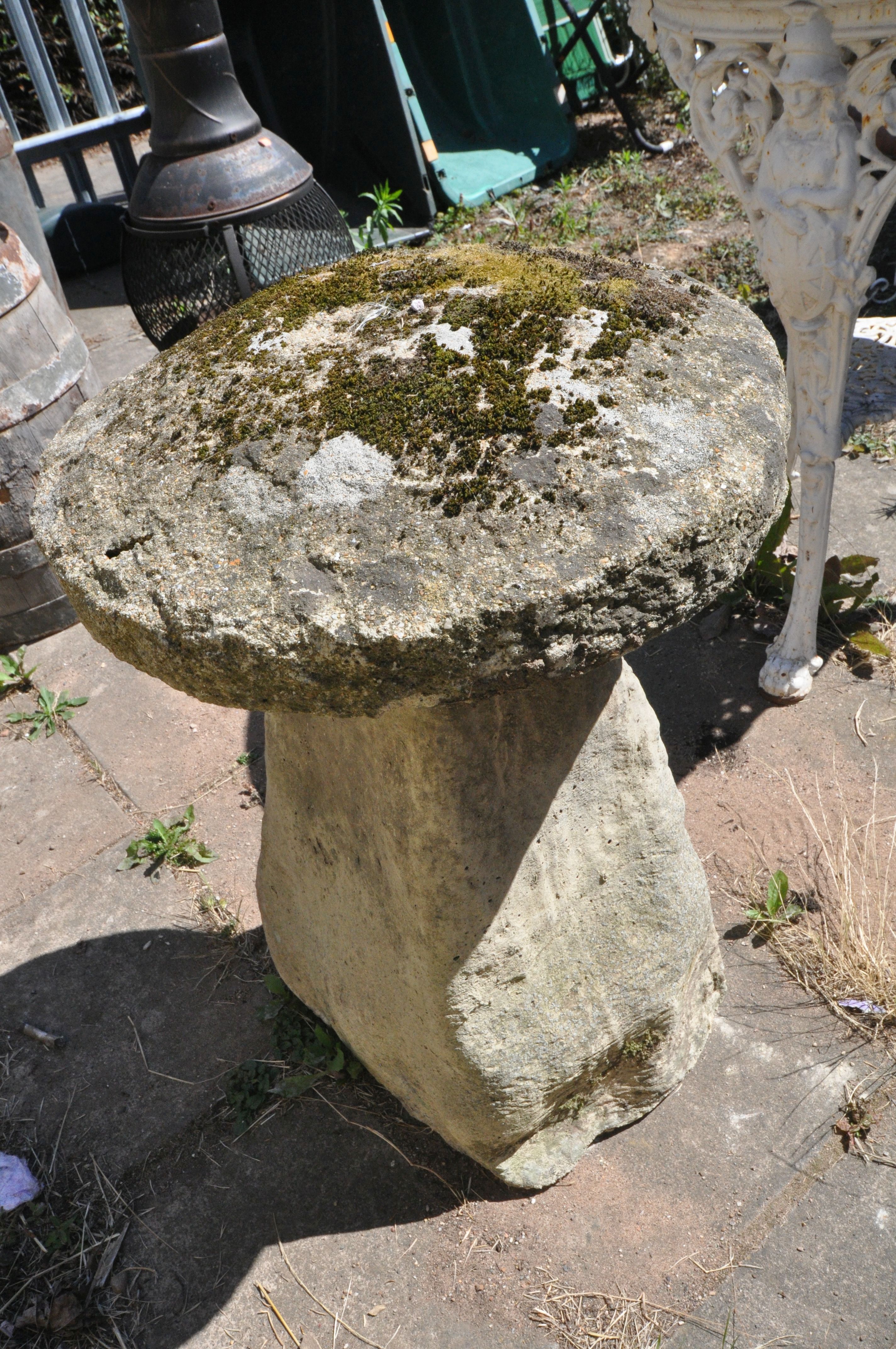 A COMPOSITE STADDLE STONE, with a weathered top, diameter 47cm x height 68cm