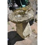 A COMPOSITE STADDLE STONE, with a weathered top, diameter 47cm x height 68cm