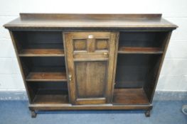 AN EARLY TO MID 20TH CENTURY OAK SIDE BY SIDE BOOKCASE, with a raised back, a single central door,