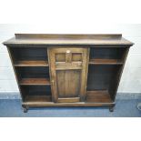 AN EARLY TO MID 20TH CENTURY OAK SIDE BY SIDE BOOKCASE, with a raised back, a single central door,