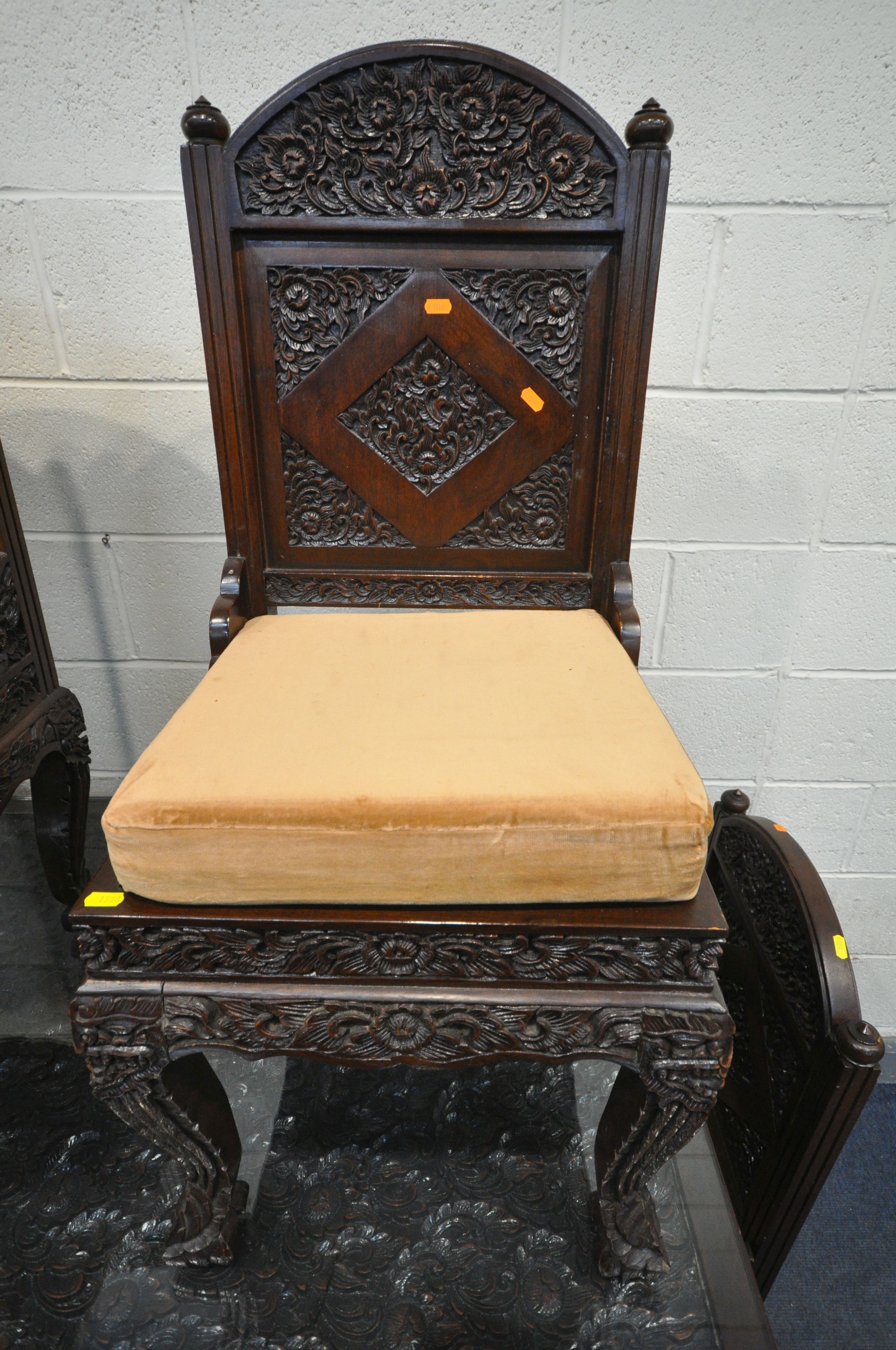 A 20TH CENTURY THAI ORIENTAL HEAVILY CARVED STAINED TEAK DINING TABLE, the recessed top with a - Image 4 of 7