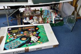 FOUR BOXES OF HOUSEHOLD SUNDRIES AND A CASINO GAME SET, to include a large seven in one Casino