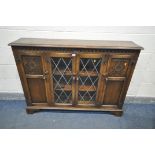 A REPRODUX OAK SLIM BOOKCASE, with two panel doors flanking two lead glazed doors, length 136cm x