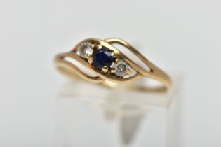 A 9CT GOLD GEM SET RING, asymmetrical design, centring on a four claw set, circular cut deep blue
