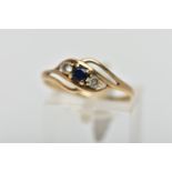 A 9CT GOLD GEM SET RING, asymmetrical design, centring on a four claw set, circular cut deep blue