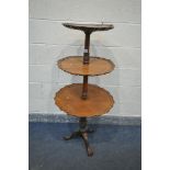 A REPRODUCTION WALNUT DUMB WAITER , with three graduated plateaus, wavy edges, turned and carved