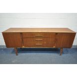 A MID CENTURY TEAK BEAUTILITY CONCAVE SIDEBOARD, with two cupboard doors, flanking three graduated