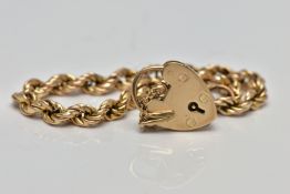 A 9CT GOLD ROPE TWIST BRACELET, hollow rope twist chain, fitted with a heart padlock hallmarked