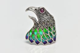 A WHITE METAL PLIQUE A JOUR, RUBY AND MARCASITE BIRD BROOCH, depicting a bird of prey's head and