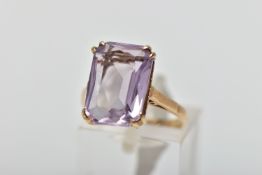 A 9CT GOLD AMETHYST SINGLE STONE RING, the rectangular shape amethyst measuring approximately 14mm x