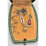 A DIAMOND PENDANT AND PASTE PENDANT, a white metal drop pendant, grain set with seven small rose cut