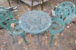 A CAST ALUMINIUM CIRCULAR GARDEN TABLE with pierced top 60cm in diameter and two similar chairs