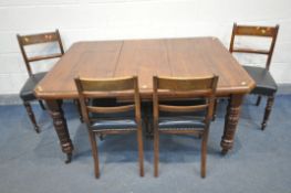 AN EDWARDIAN WALNUT WIND OUT DINING TABLE, with canted corners, one additional leaf, with turned