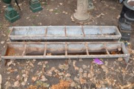 A TWO GALVANISED ANIMAL FEED TROUGHS both 183cm long (one slightly taller than the other) (some