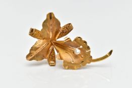 A YELLOW METAL FLOWER BROOCH, a floral brooch detailing a flower, leaves and stem, set with a single