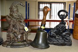 A VINTAGE WOODEN HANDLED SCHOOL BELL AND TWO VICTORIAN CAST IRON DOORSTOPS, the bell height 28.