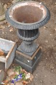 A SMALL 20th CENTURY CAST IRON CAMPAGNA URN ON STAND with fluted detailing to bowl and a plain