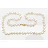 A CASED IMITATION PEARL NECKLACE, a single row of white imitation pearl beads individually knotted