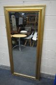 A MODERN GILTWOOD BEVELLED EDGE WALL MIRROR, made by Richmond Mirror, length 170cm x width 80cm