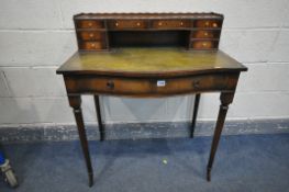 AN EDWARDIAN STYLE MAHOGANY WRITING DESK, with an assortment of nine drawers, green tooled leather