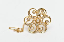 A YELLOW METAL SPLIT PEARL FLORAL BROOCH, of scrolling design, the central split pearl with six