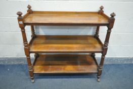 A LATE VICTORIAN OAK THREE TIER BUFFET, with shaped finials to each corner, supported by reeded