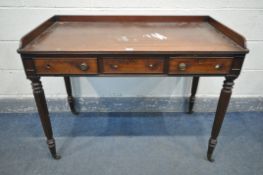 AN EARLY VICTORIAN MAHOGANY SIDE TABLE, with a gallery top, and three frieze drawers, on fluted