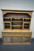 A LARGE 19TH CENTURY PINE DRESSER, the top with an arrangement of shelves, surrounded two glazed