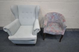 A LIGHT BLUE UPHOLSTERED WING BACK ARMCHAIR, along with a mid-century floral upholstered tub