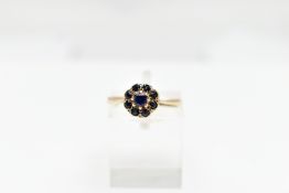 A 9CT GOLD SAPPHIRE CLUSTER RING, the circular cut central sapphire with similar cut sapphire