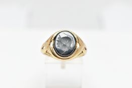 A 9CT GOLD HEMATITE INTAGLIO SIGNET RING, of an oval form depicting a side profile of a soldier