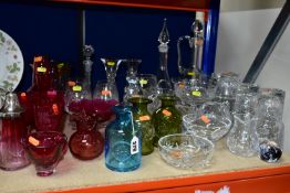 A COLLECTION OF COLOURED AND CLEAR GLASSWARE, including a pair of carafe and glass sets engraved