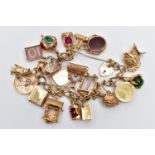 A 9CT YELLOW GOLD CHARM BRACELET, the curb link bracelet, suspending approximately twenty charms, to