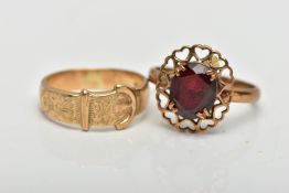 TWO YELLOW METAL RINGS, to include a buckle ring, stamped 9ct, together with a garnet single stone