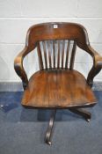 A 20TH CENTURY OAK OFFICE CHAIR, with arched back, and open armrests, with four swept legs on