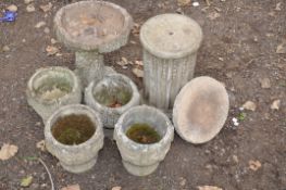 A SET OF FOUR COMPOSITE GARDEN PLANTERS 27cm in diameter and 24cm high ( some cracks), a tree