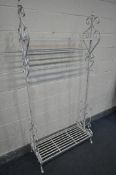 A WHITE PAINTED METAL CLOTHES RAIL, with one upper shelf, above a single rail, and a shoe shelf,